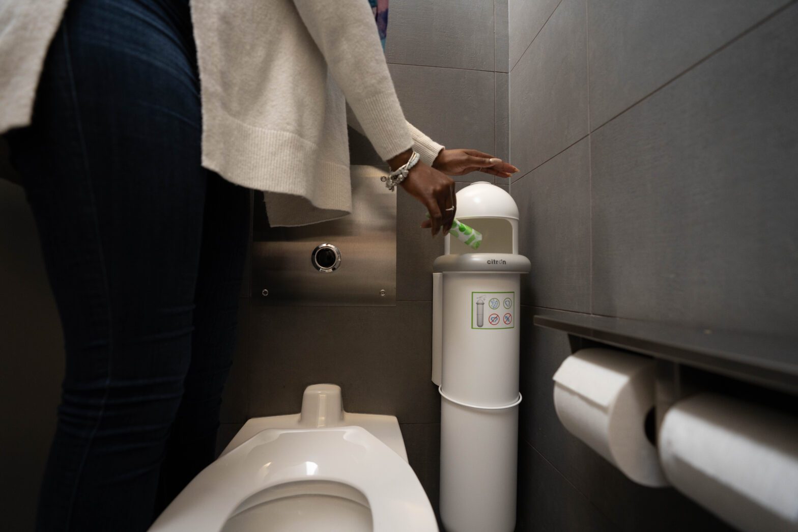 Woman disposal of tampon in a Menstrual hygiene disposal unit